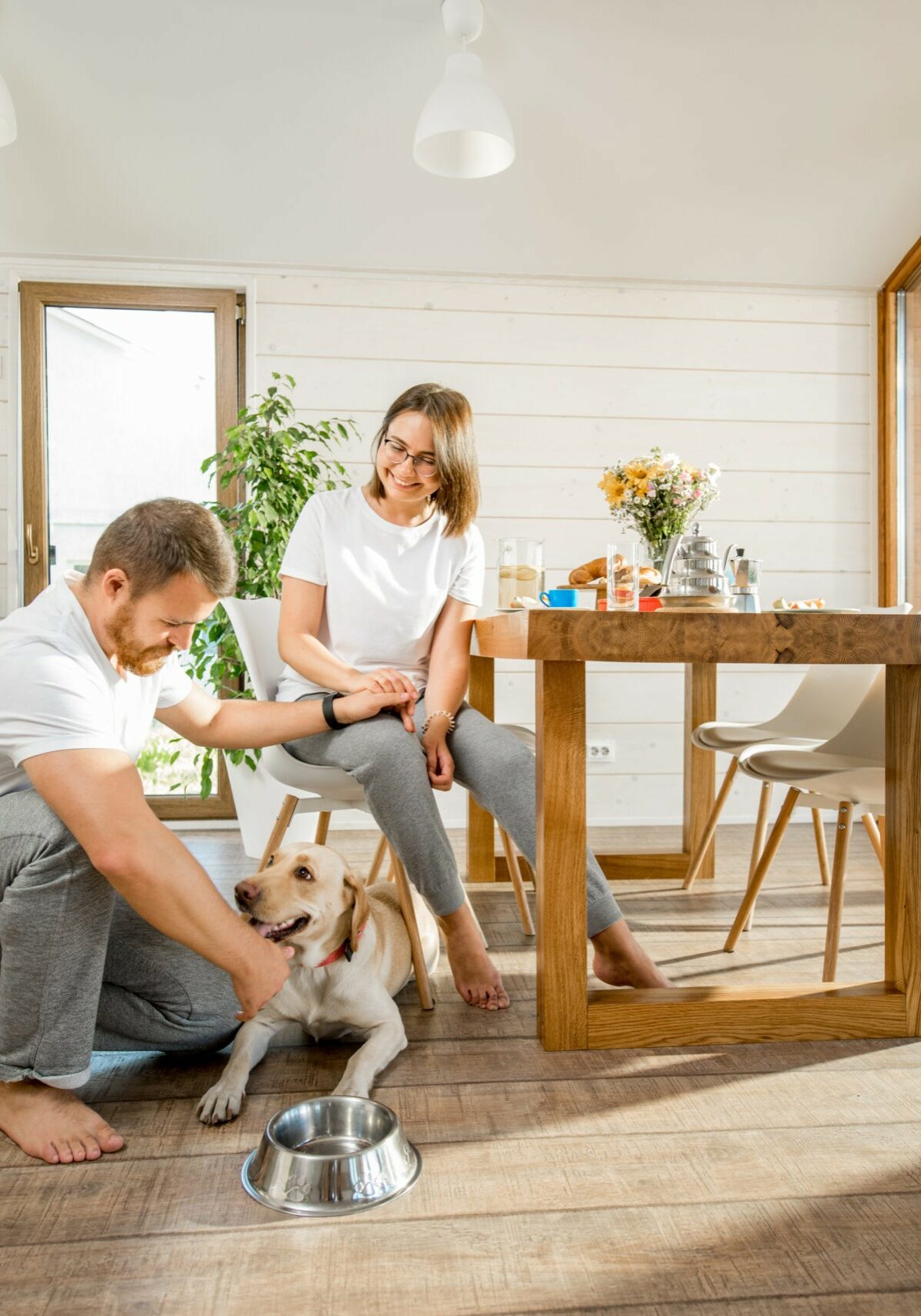 Happy couple with dog at home | Flooring & Tile World