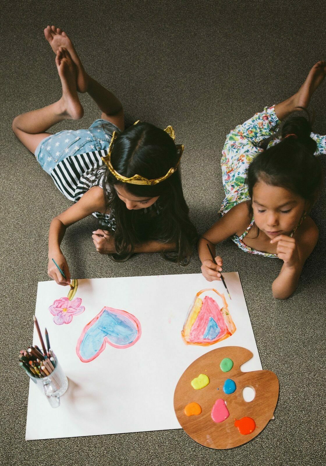 Girls drawing laying on soft carpet | Flooring & Tile World