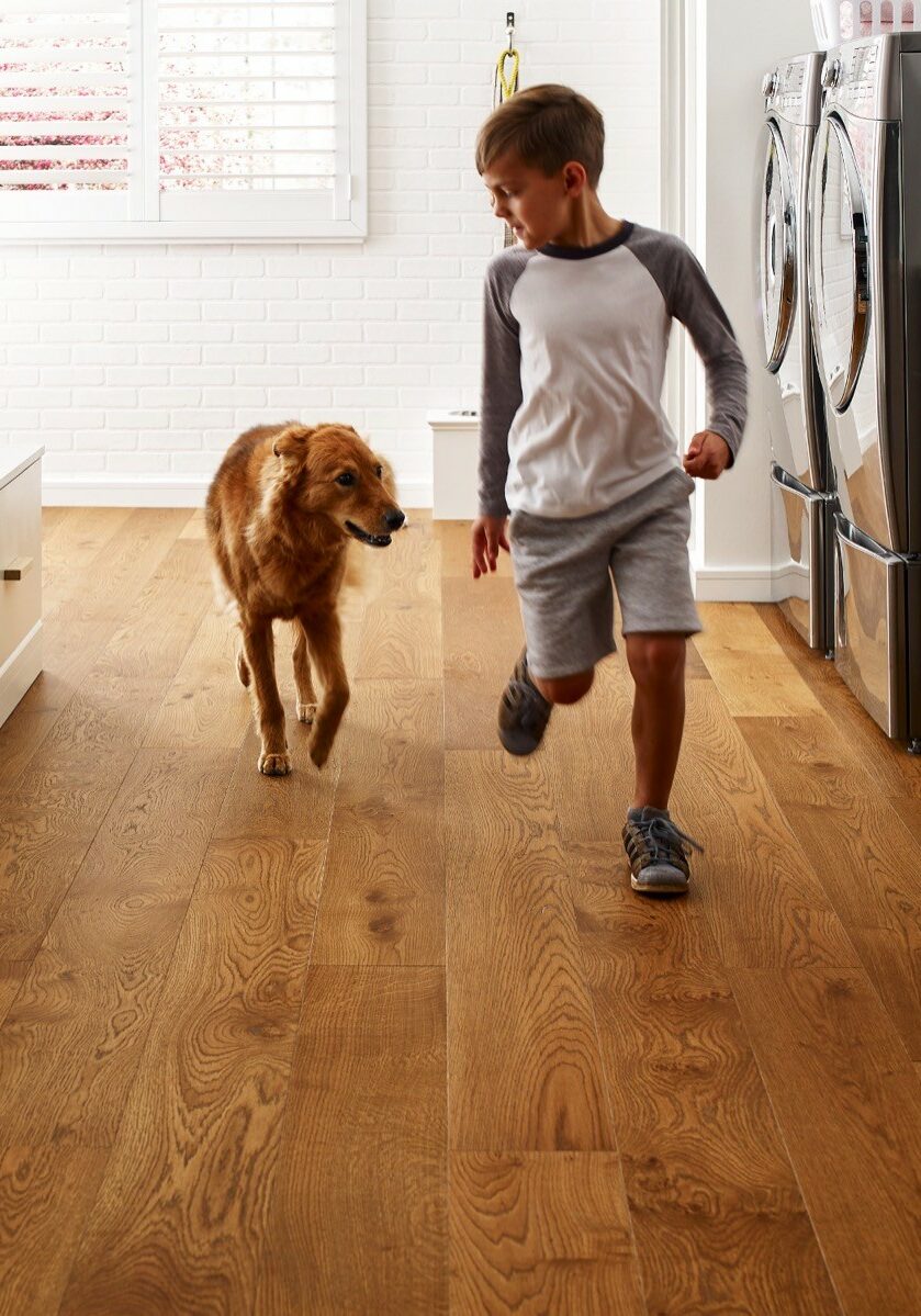 Kid running with dog | Flooring & Tile World